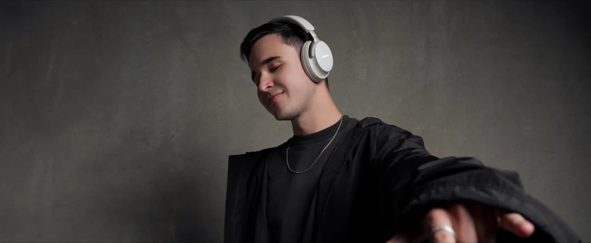 A pair of premium noise-canceling headphones resting on a travel map.