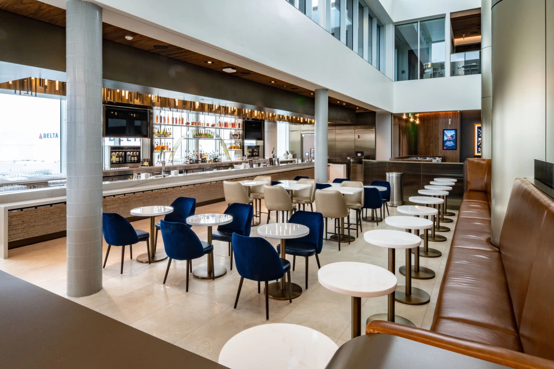 A business professional working in an airport lounge, symbolizing the card's premium access.